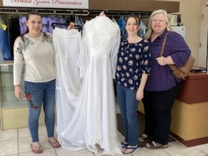 Wedding Gown restoration 35 year old;Bride happy and excited to wear the restored wedding gown; 